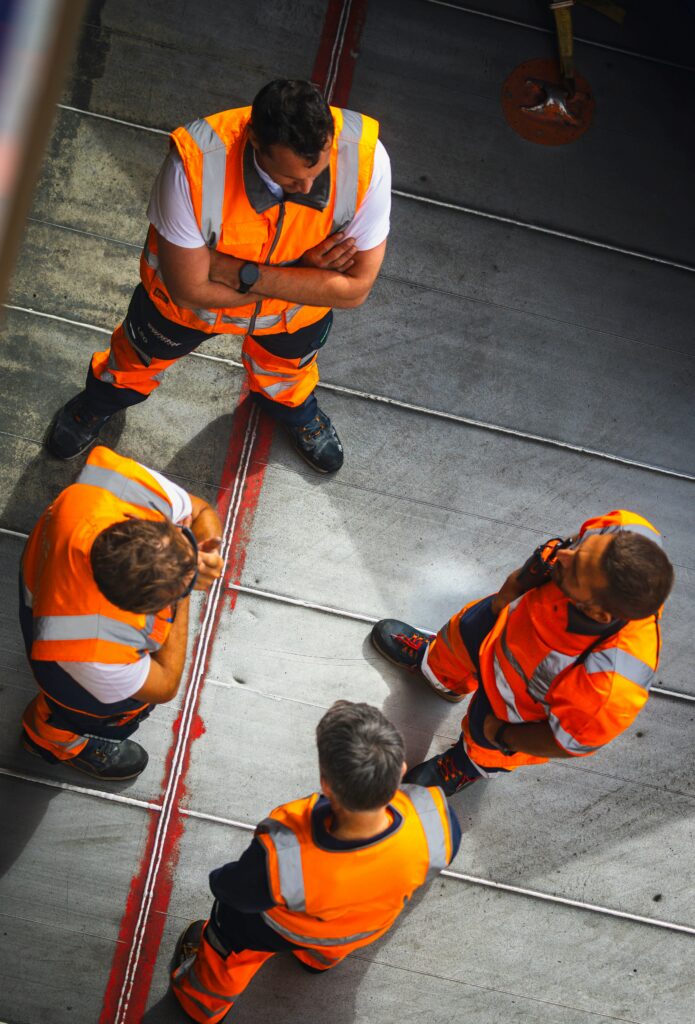 Rail engineers in orange safety gear on site